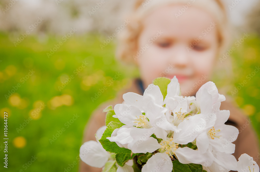 little girl holding out bouquet of flowers apple trees little girl holding out bouquet of flowers apple trees