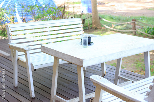 white woden table in garden for rest and relax after raining