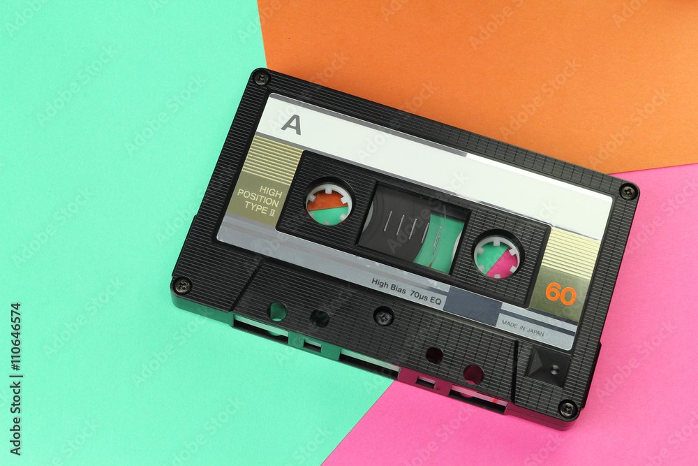 Obraz premium Audio Compact Cassette C60 tape with a blank label on a colored background