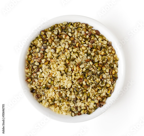 Bowl of hemp seeds isolated on white, from above © bigacis