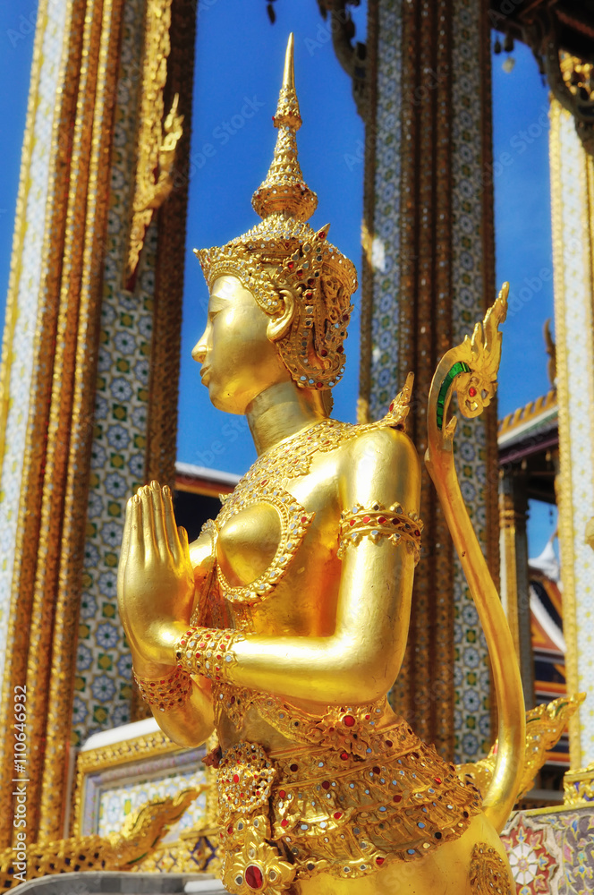 Sawasdee or hello in Thai Language. Close-up golden statue of Kinara at Wat Phra Kaew in Grand Place Complex in Bangkok, Thailand