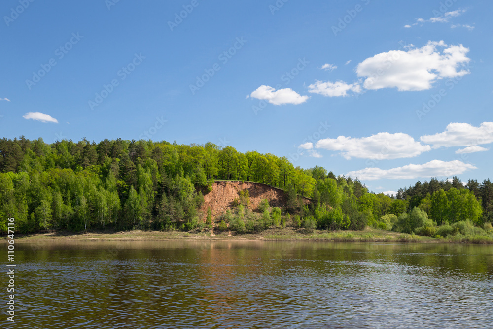 view to river with reflections and blue cloudy sky view to river with reflections and blue cloudy sky