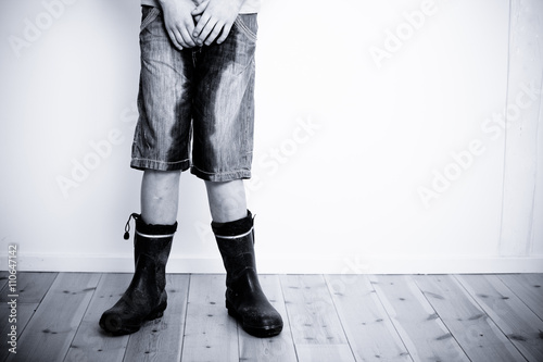 Legs of teenager with wet pants and boots photo