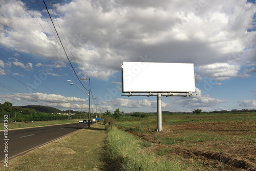 Billboard - Empty billboard in front of beautiful cloudy sky in a rural location