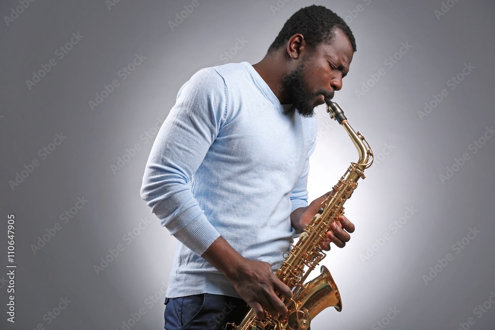 Naklejka premium African American jazz musician playing the saxophone
