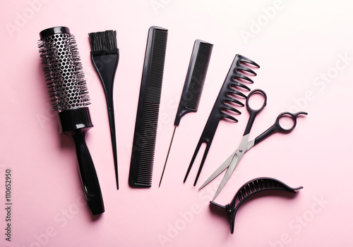 Hairdresser set with various accessories on pink background