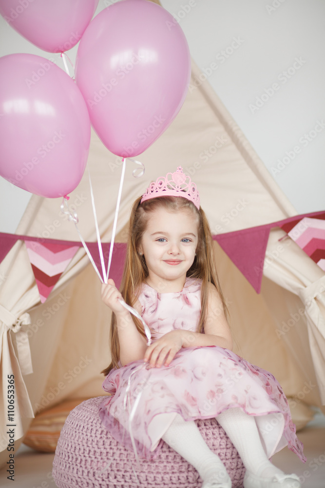 Birthday girl wearing a pink dress and crown