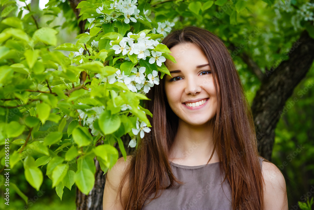 young woman the brunette in the spring blossoming garden young woman the brunette in the spring blossoming garden