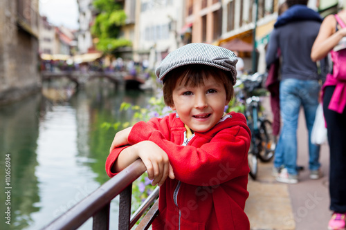 Sweet portrait of preschool boy in the town of Annecy, France, s