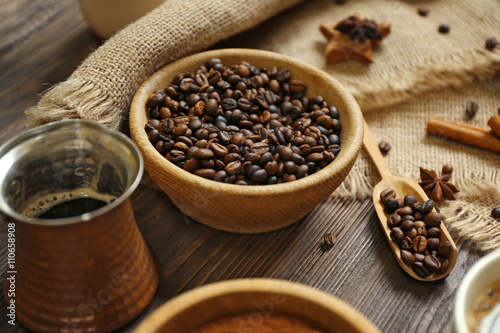Coffee with beans and spices on wooden table closeup