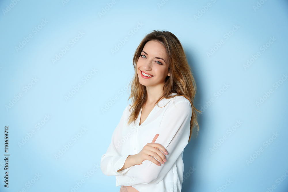 Portrait of young businesswoman against blue wall background Portrait of young businesswoman against blue wall background