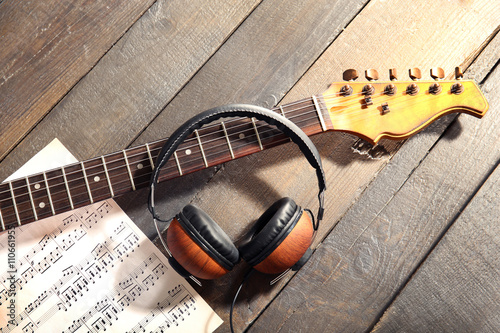 Guitar and headphones on wo...