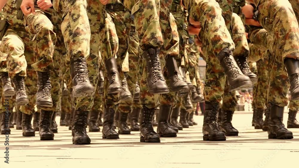 Soldiers marching in a parade through the town in slow motion,  Slow Motion Video Clip