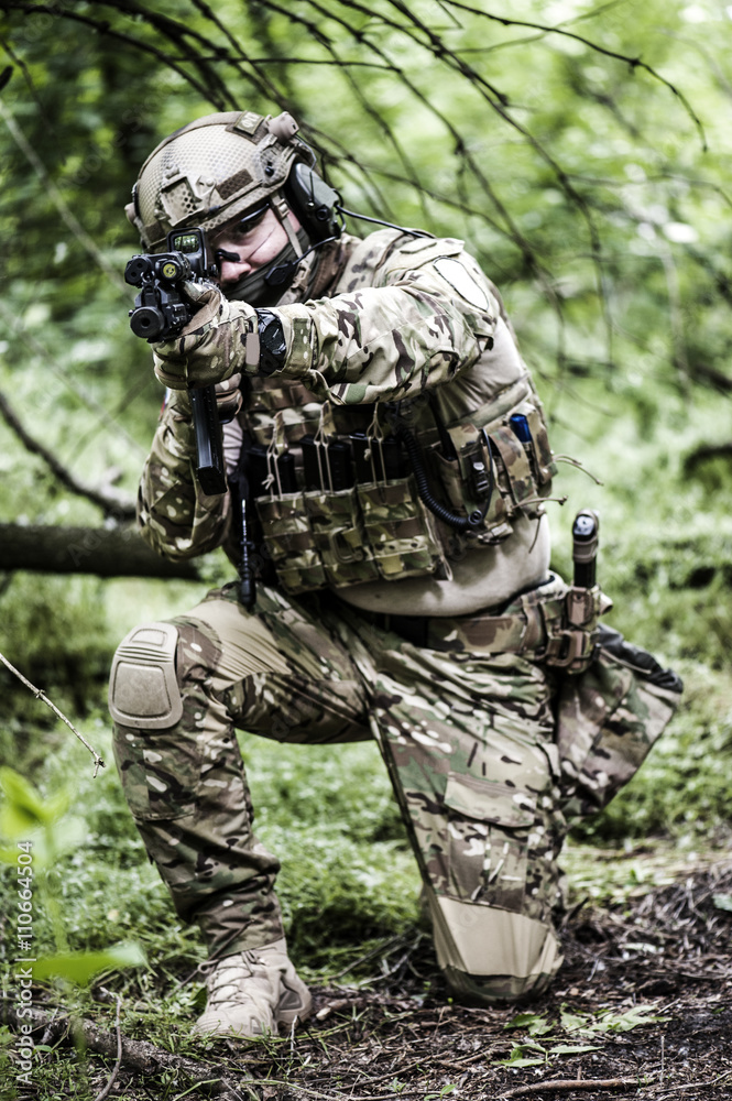 Special forces in wood focus on gun Special forces in wood focus on gun