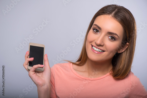 Pleasant woman holding cellphone