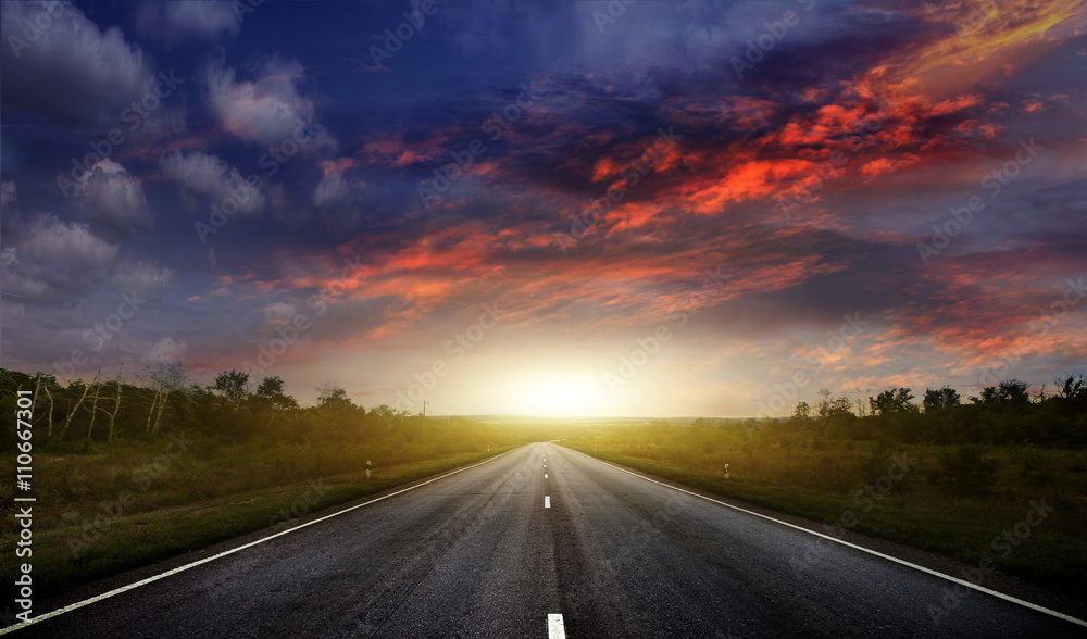 Fototapeta premium Country road with a dark sky