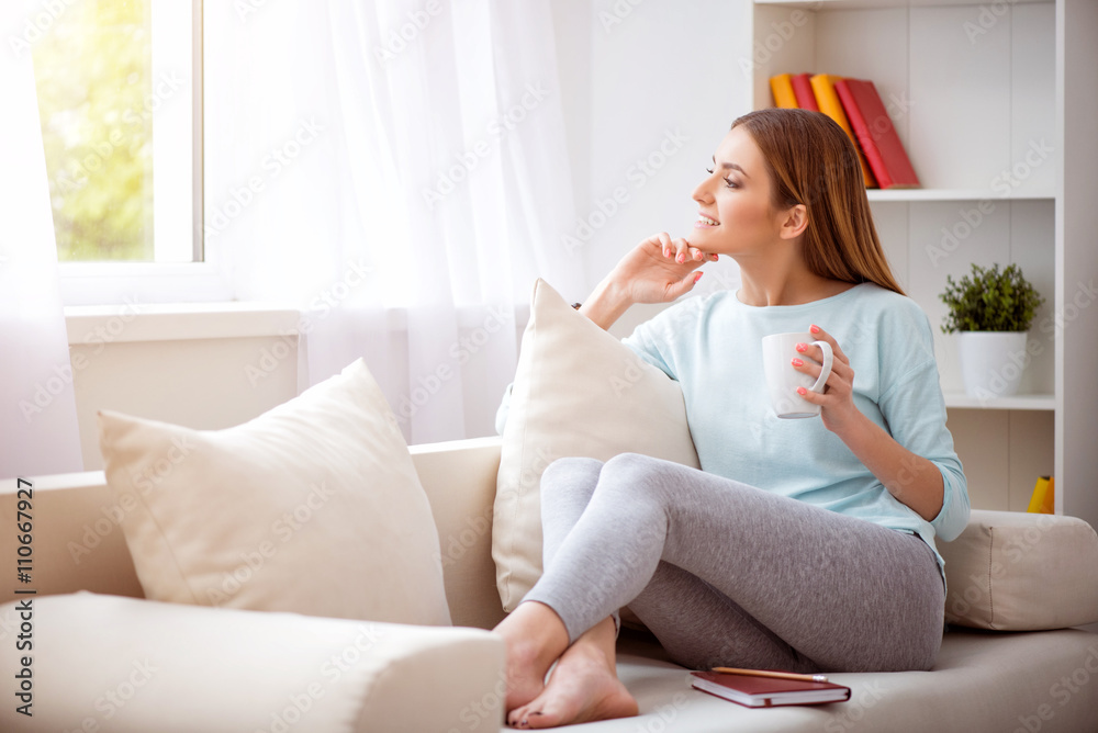 Pleasant beautiful woman resting on the couch Pleasant beautiful woman resting on the couch