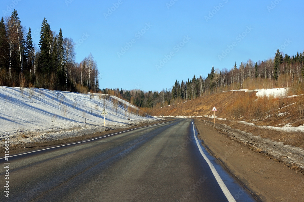 A colorful winter road with a turn and a road sign to use as a generic background
A colorful winter road with a turn and a road sign to use as a generic background