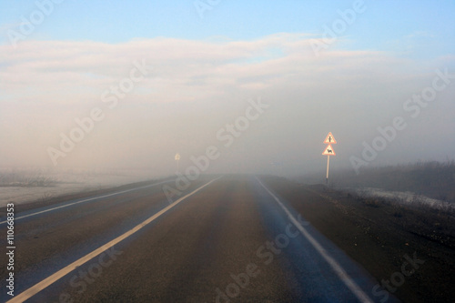 A road leading into a heavy fog ahead  