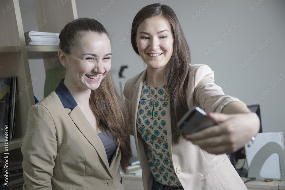 Two young girls student office worker photographed themselves on the phone selfie Two young girls student office worker photographed themselves on the phone selfie