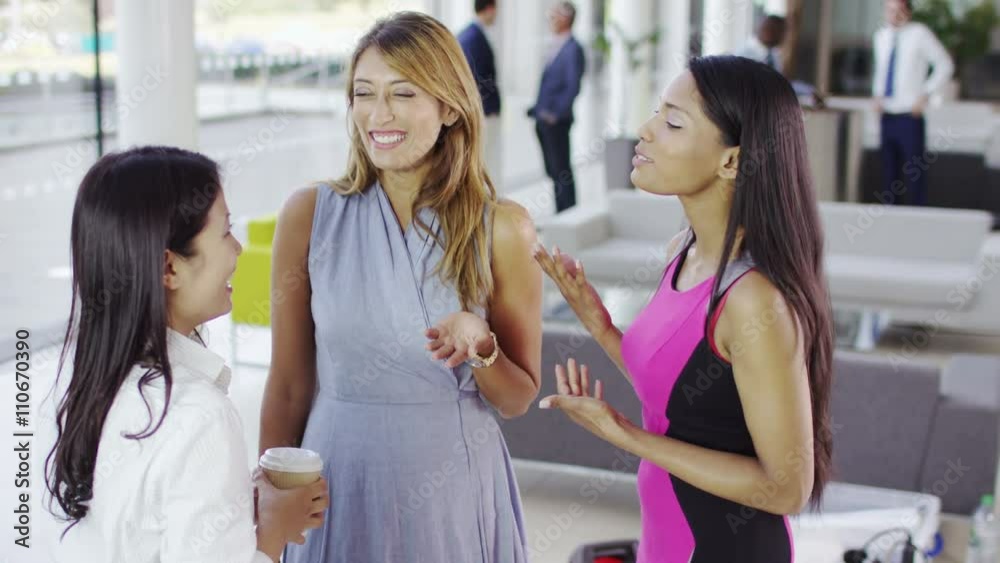 Happy female business group chatting together in modern office Happy female business group chatting together in modern office