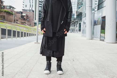 Detail of a stylish man posing in the street