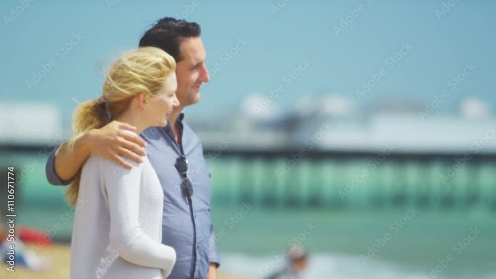 Portrait of romantic couple on beach, smiling to camera. Portrait of romantic couple on beach, smiling to camera.
