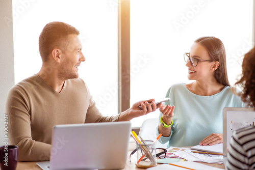 Positive colleagues sitting at the table 