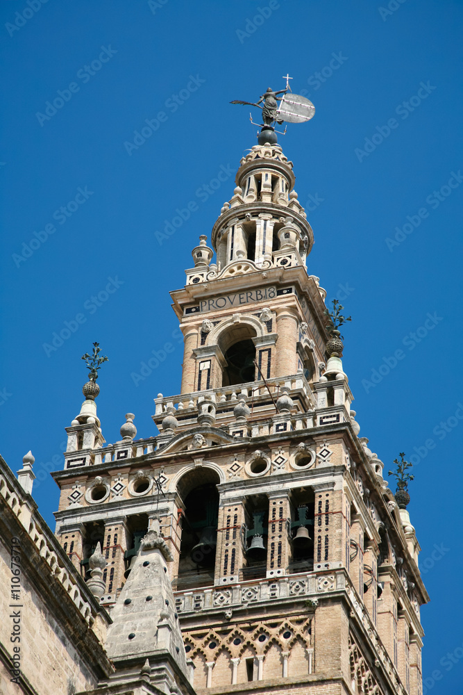 famous belfry named Giralda and vane Giraldillo, in landmark catholic cathedral of Saint Mary of the See, public gothic monument year 1507, World Heritage by UNESCO, in Seville, Andalusia, Spain