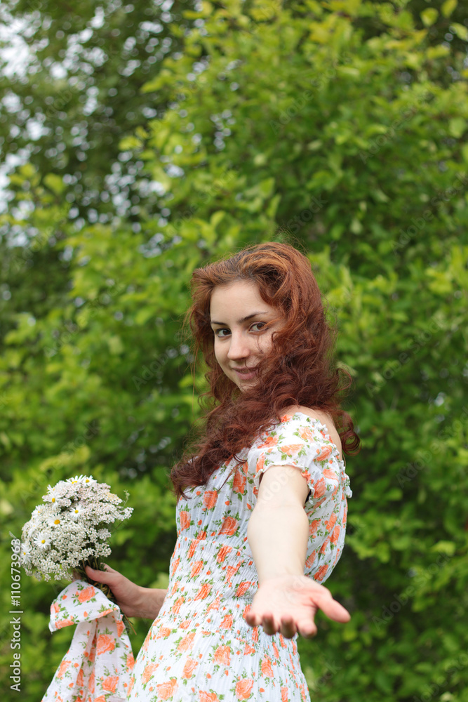 beautiful girl with a bouquet of wildflowers