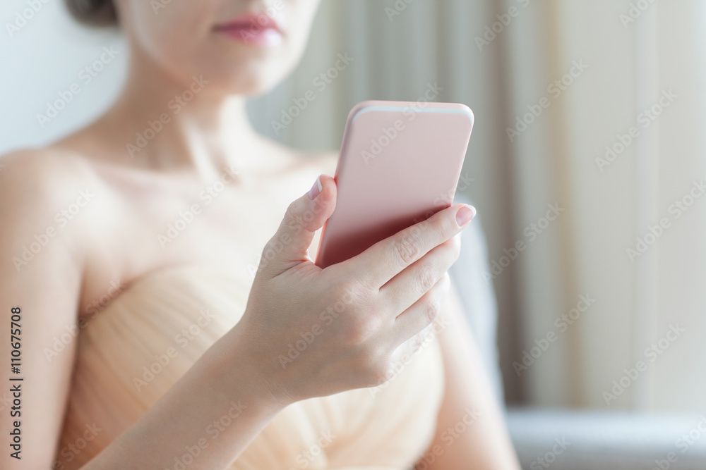 beautiful woman holding a pink phone