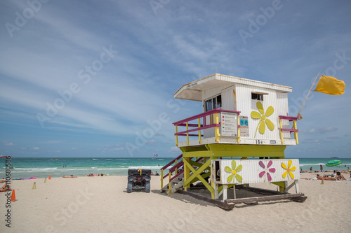 Miami Beach, Florida - May 9th 2014 - Tourists and locals enjoying a sunny day at Miami beach. Green water and blue sky. Miami, Florida, USA. © LMspencer