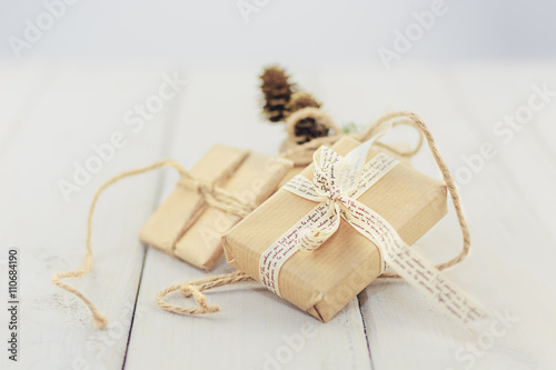 Three boxes tied with a rope, ribbon and decorate with a sprig o