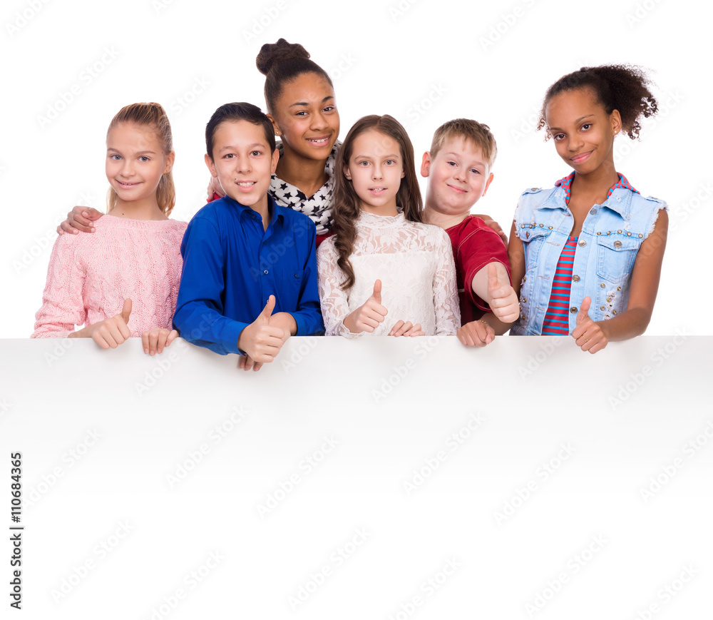 joyful teenagers with thumbs up holding an empty blank isolated on white background joyful teenagers with thumbs up holding an empty blank isolated on white background