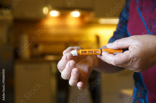 Hyperglycemic diabetic patient opening her insulin shot