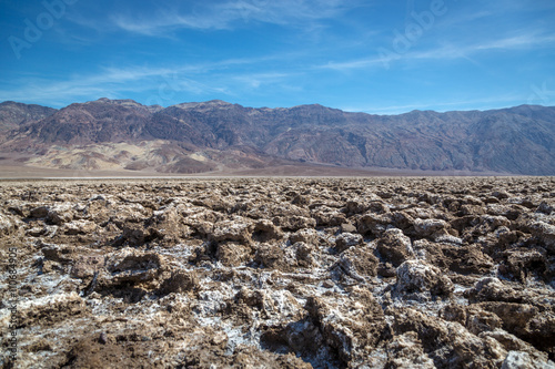 Beautiful scenario, sand formations in the foreground, blue sky day at the Death Valley National Park, Arizona, USA