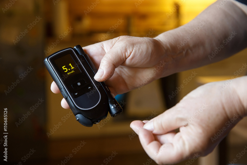 Diabetic patient testing her blood for sugar level
