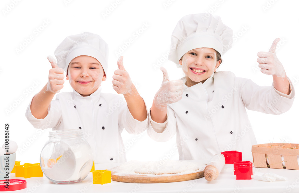 funny little cooks in kitchen with thumbs up and flour on faces and hands funny little cooks in kitchen with thumbs up and flour on faces and hands
