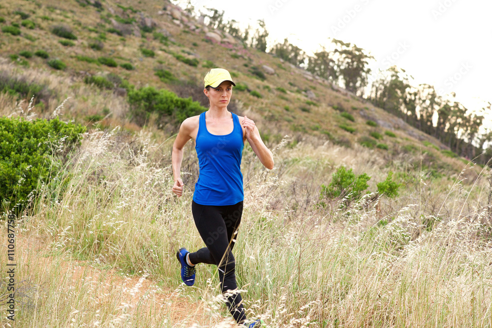 Active older woman running in nature Active older woman running in nature