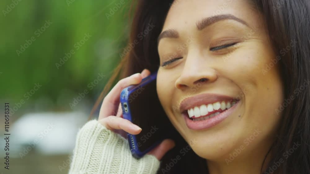 Attractive Asian woman talking on mobile phone in the city Attractive Asian woman talking on mobile phone in the city