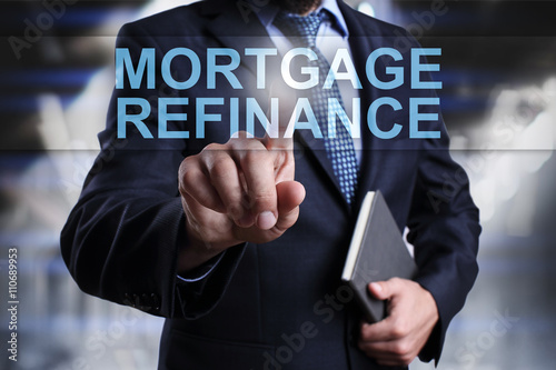 Businessman is pressin on virtual screen and selecting "Morgage refinance"
