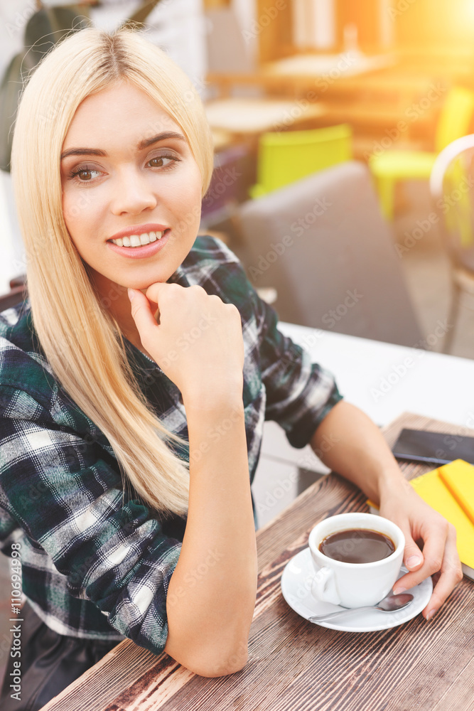 Beautiful young woman is relaxing in cafeteria Beautiful young woman is relaxing in cafeteria