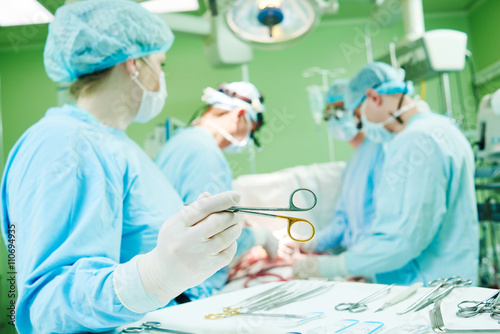surgeons at work. female nurse operating in child surgery hospital photo