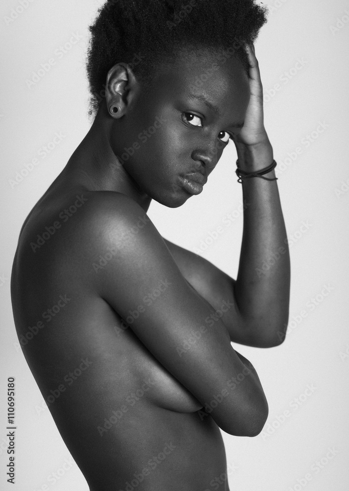 Portrait of naked black woman looking at camera Stock Photo | Adobe Stock