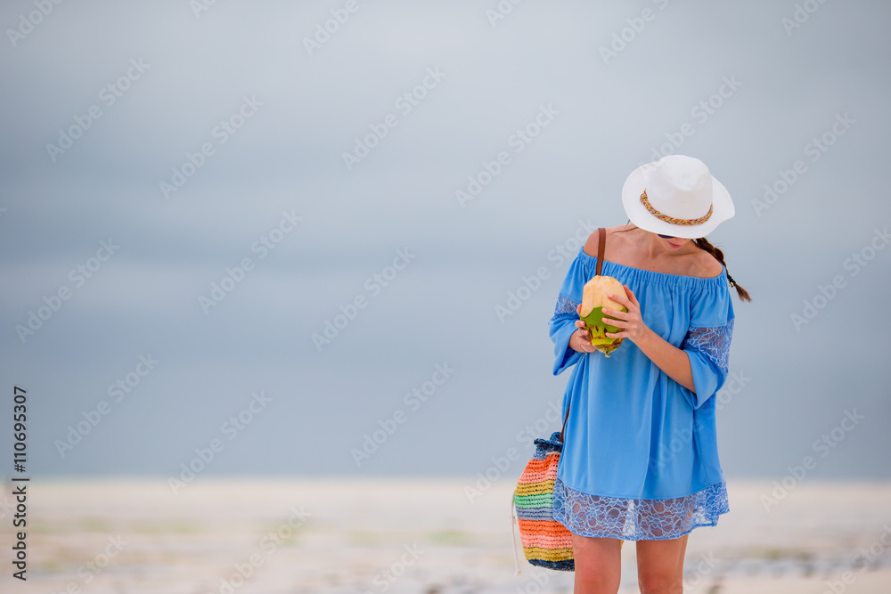 Young woman with coconut during tropical vacation
