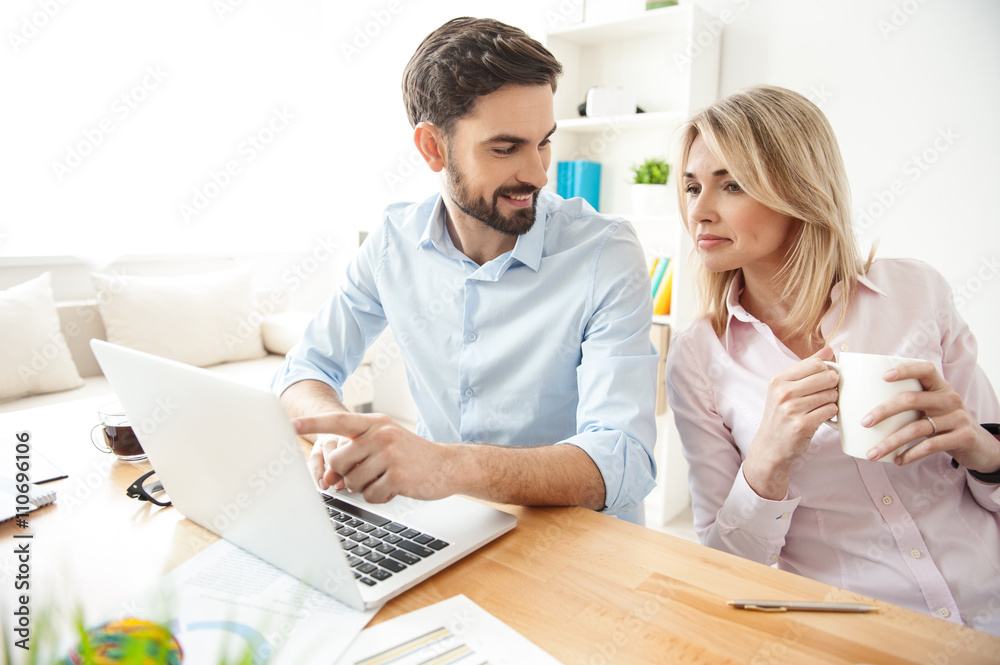 Pretty young colleagues are working with joy Pretty young colleagues are working with joy