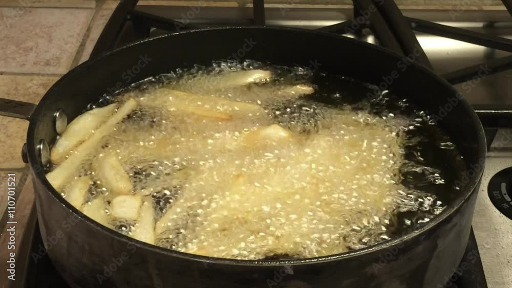 HD Video of Medium sized Russet potatoes peeled, sliced and frying in hot oil creating home made french fries. An inexpensive alternative to fast food restaurants. HD Video of Medium sized Russet potatoes peeled, sliced and frying in hot oil creating home made french fries. An inexpensive alternative to fast food restaurants.