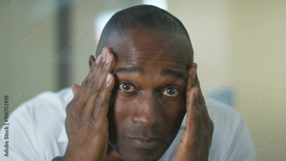  Close up portrait man in bathroom going through skin care routine 