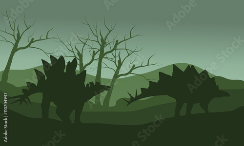 Silhouette of stegosaurus in hills