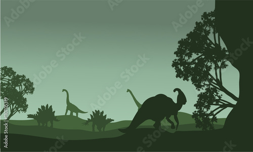 Silhouettte of parasaurolophus and stegosaurus